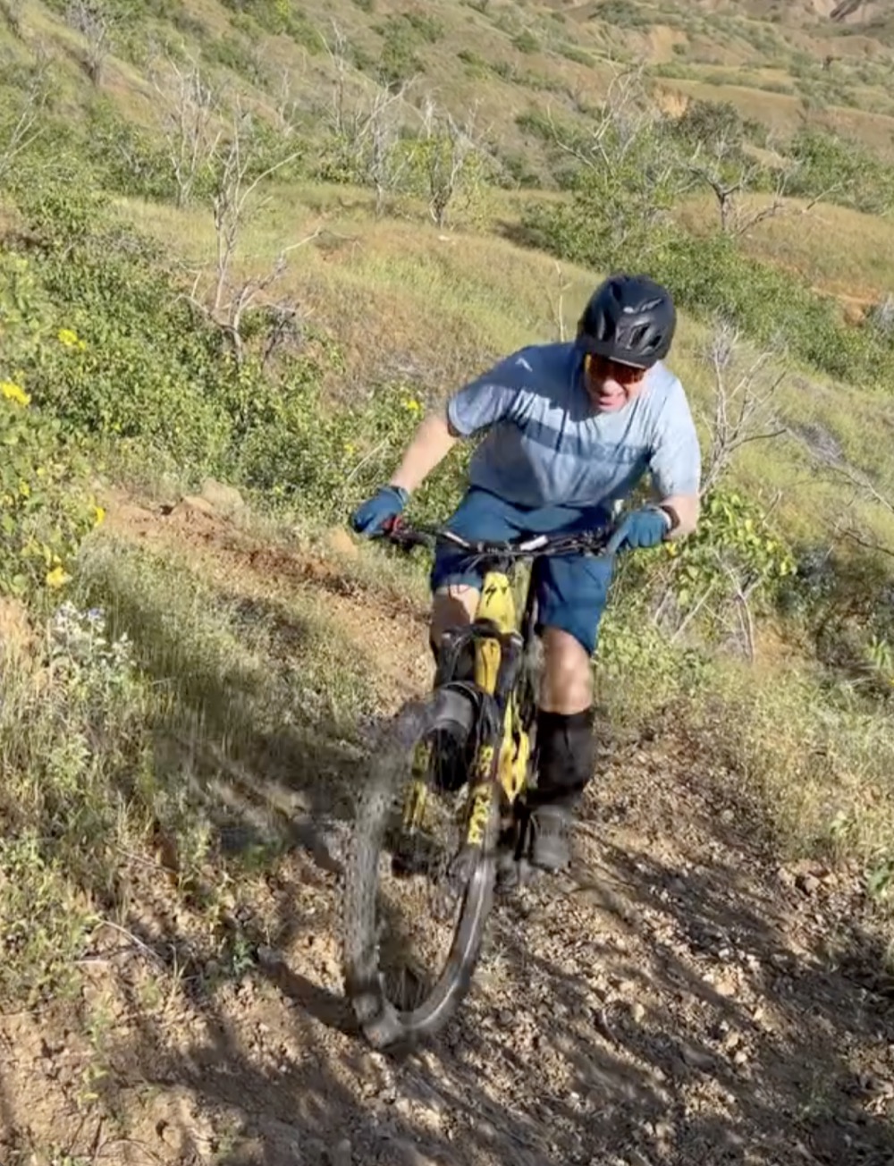 A rider descending a dirt trail in the hills behind Mancora